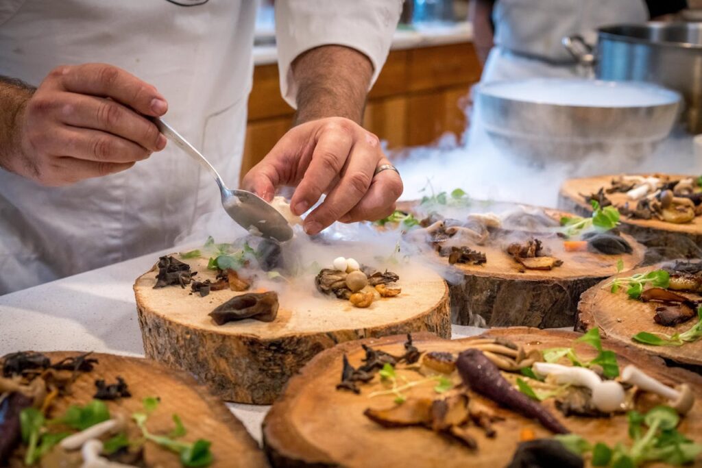 Fresh vegetables being sliced on a wooden cutting board